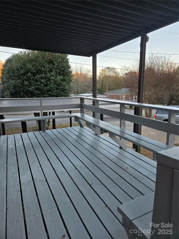 a view of balcony with wooden floor and outdoor seating
