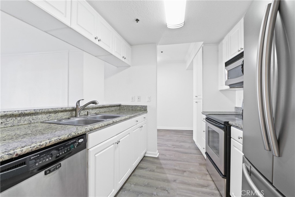 a kitchen with a sink stove and refrigerator