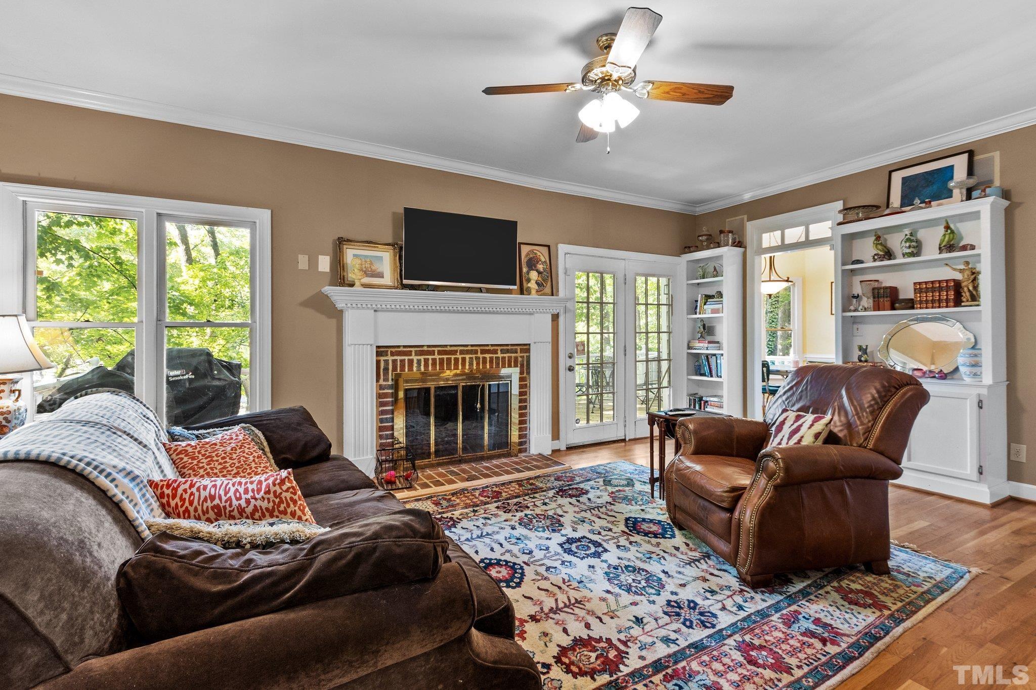 2516 Ashley Court Raleigh, NC 27607 - Photo 14 of 48 a living room with furniture a fireplace and a flat screen tv