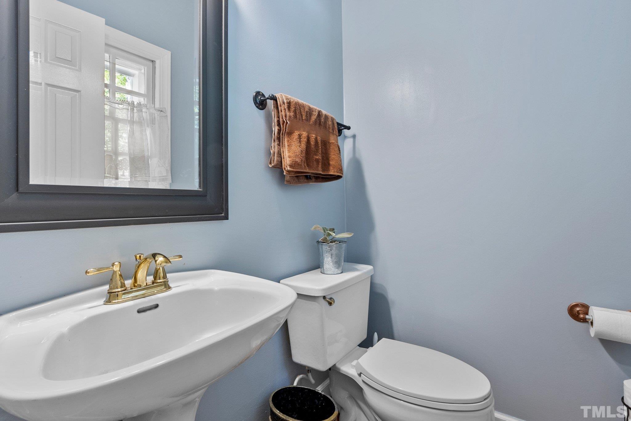 2516 Ashley Court Raleigh, NC 27607 - Photo 21 of 48 a bathroom with a sink mirror and toilet