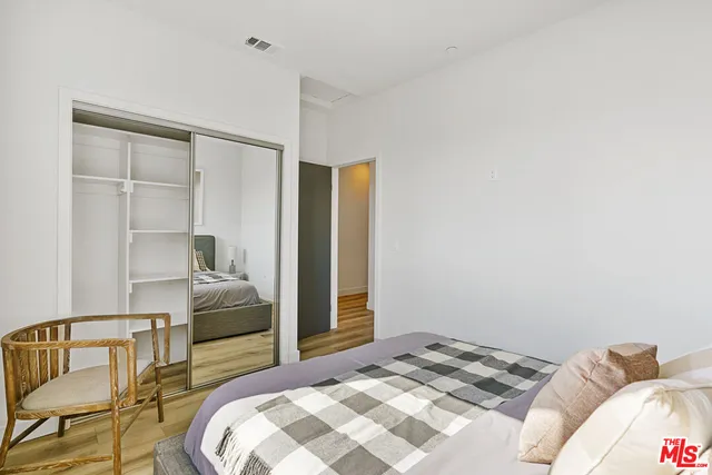 a bedroom with a bed and a chair