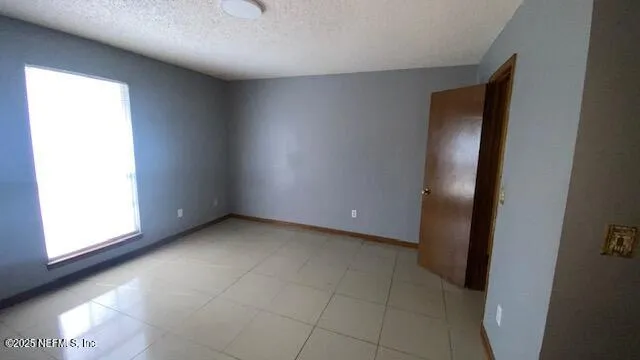 an empty room with windows and entrance