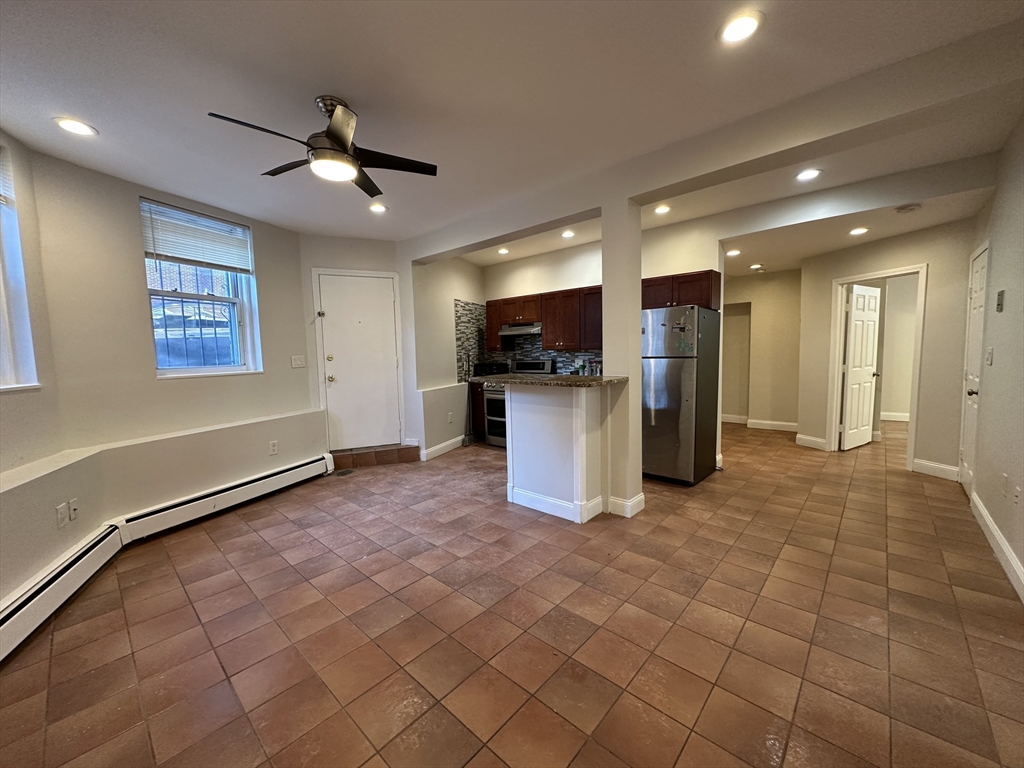 109 Strathmore Road, Unit B Boston, MA 02135 - Photo 2 of 9 a view of a kitchen with a sink and a microwave