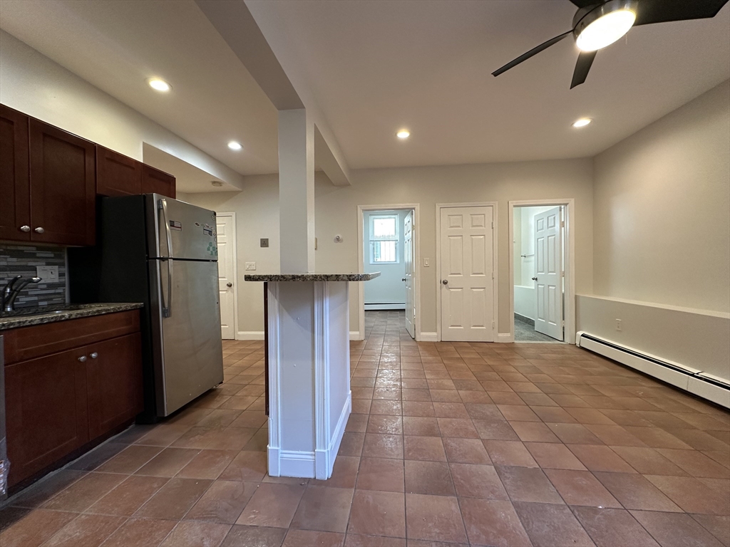 109 Strathmore Road, Unit B Boston, MA 02135 - Photo 3 of 9 a kitchen with stainless steel appliances granite countertop a refrigerator and a stove