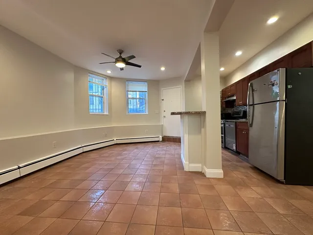 a view of a kitchen with a sink and refrigerator