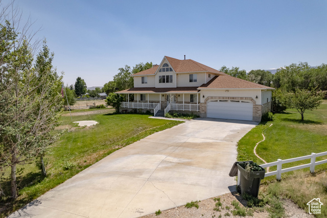 190 600 North Ferron, UT 84523 - Photo 2 of 85 View of front of property with a porch, a garage, concrete driveway, brick and vinyl exterior.