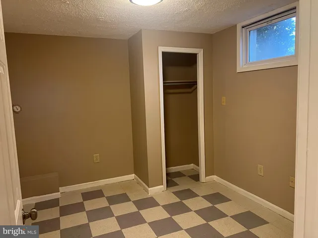 a view of a bathroom with a black and white checkered floor