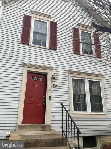 a view of a brick house with large windows