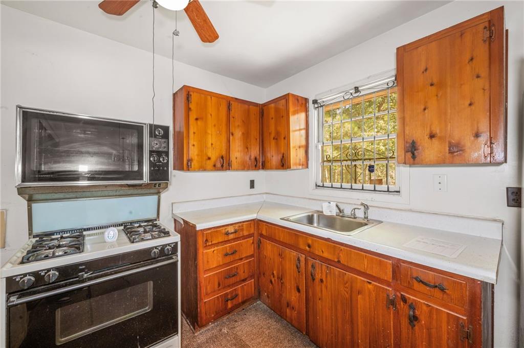 679 Bolton Road Northwest Atlanta, GA 30331 - Photo 11 of 30 a kitchen with a stove and a sink