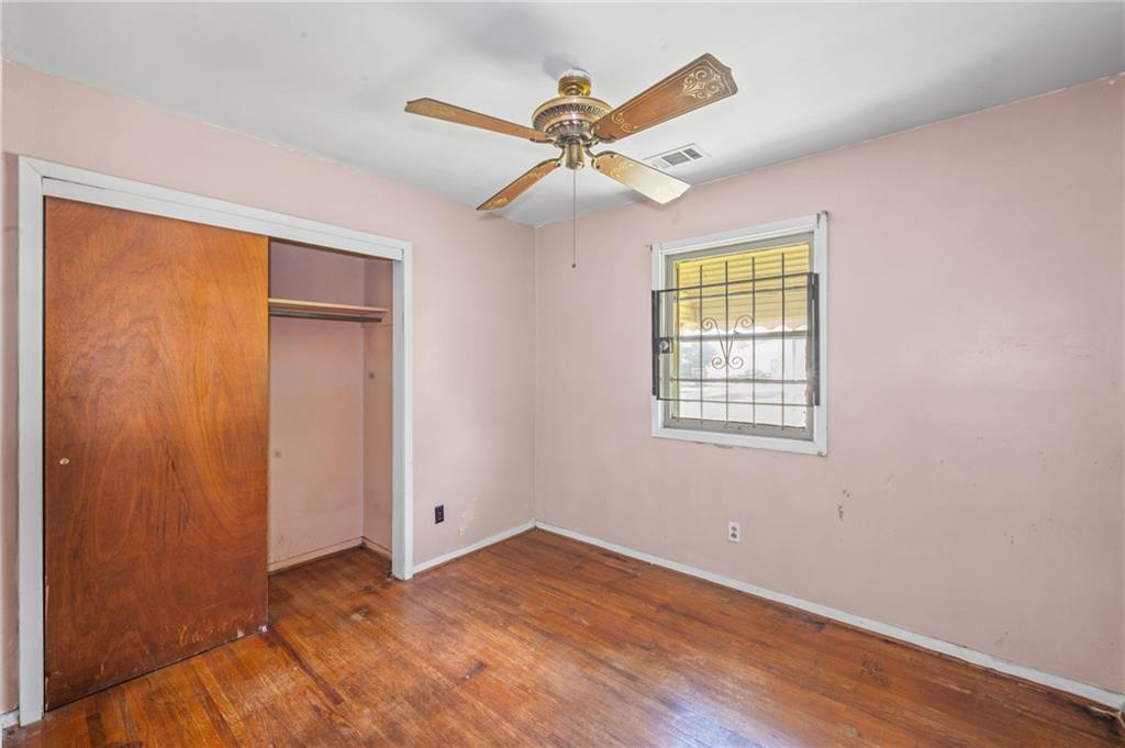 679 Bolton Road Northwest Atlanta, GA 30331 - Photo 14 of 30 wooden floor in an empty room with a window