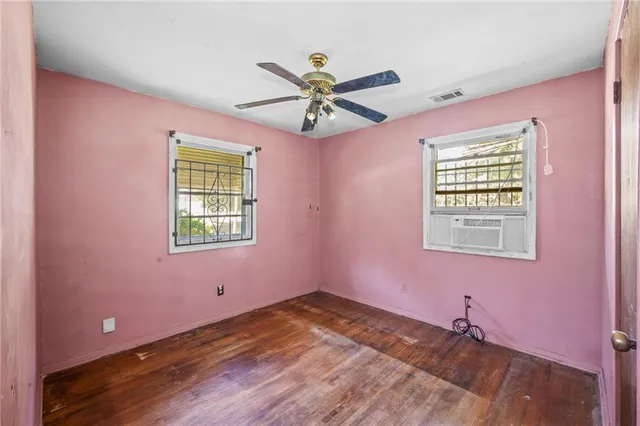 a view of a livingroom with a window and a ceiling fan