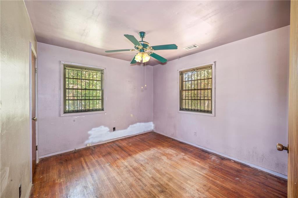 679 Bolton Road Northwest Atlanta, GA 30331 - Photo 19 of 30 wooden floor in an empty room with a window
