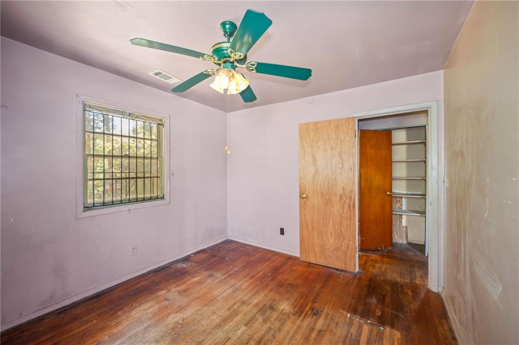 679 Bolton Road Northwest Atlanta, GA 30331 - Photo 20 of 30 wooden floor in an empty room with a window