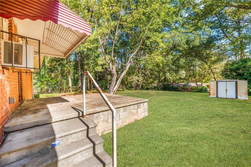 679 Bolton Road Northwest Atlanta, GA 30331 - Photo 22 of 30 a view of a house with a backyard