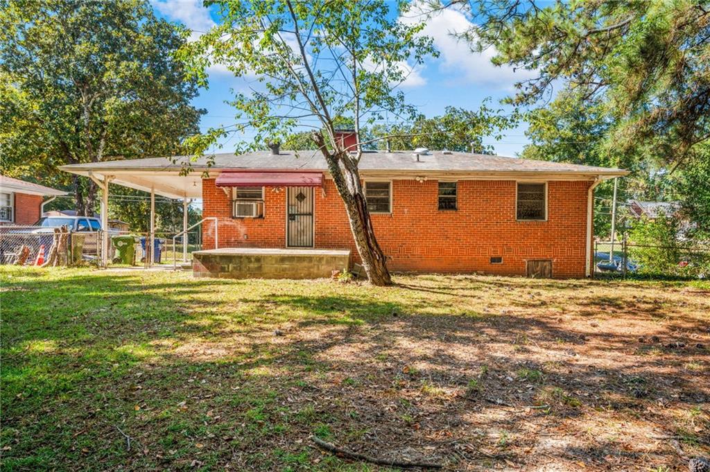 679 Bolton Road Northwest Atlanta, GA 30331 - Photo 24 of 30 a front view of house with yard and trees in the background