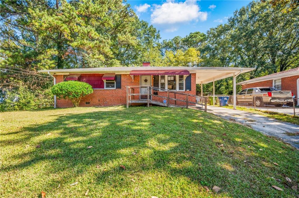 679 Bolton Road Northwest Atlanta, GA 30331 - Photo 30 of 30 a front view of a house with a yard table and chairs