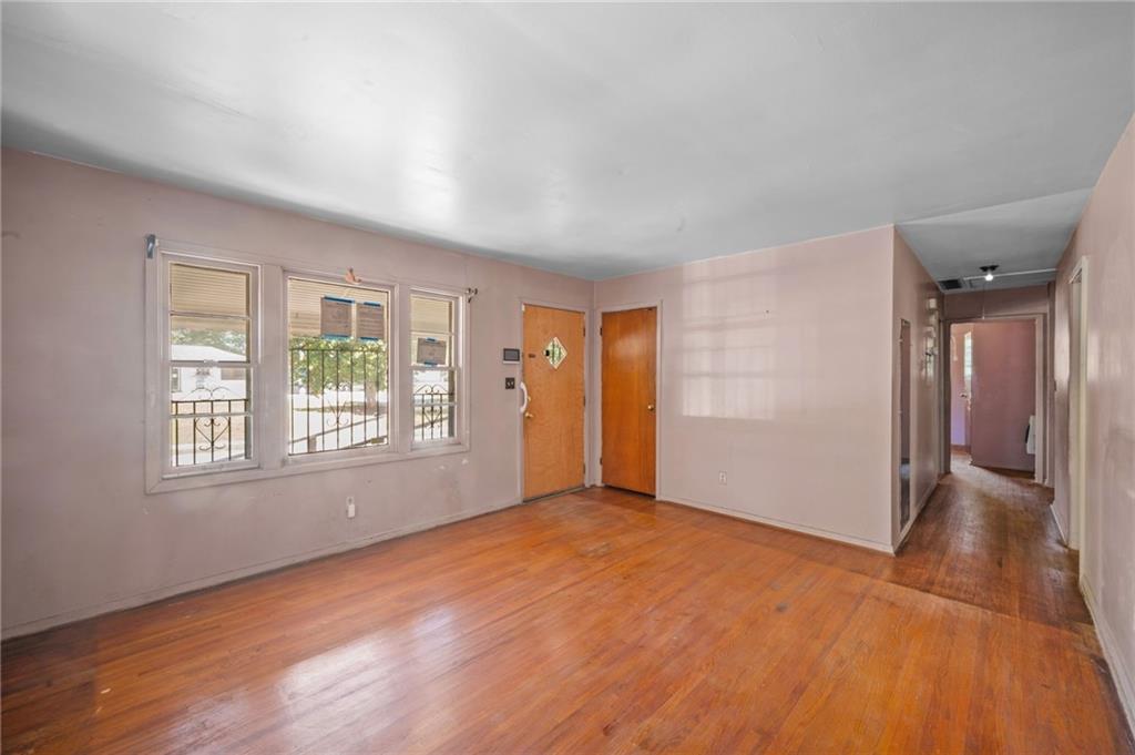 679 Bolton Road Northwest Atlanta, GA 30331 - Photo 4 of 30 a view of an empty room with wooden floor and a window