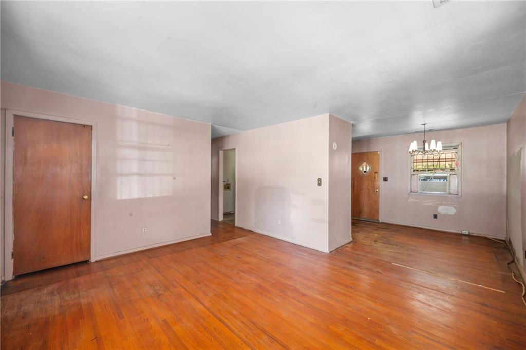 679 Bolton Road Northwest Atlanta, GA 30331 - Photo 6 of 30 an empty room with windows and wooden door