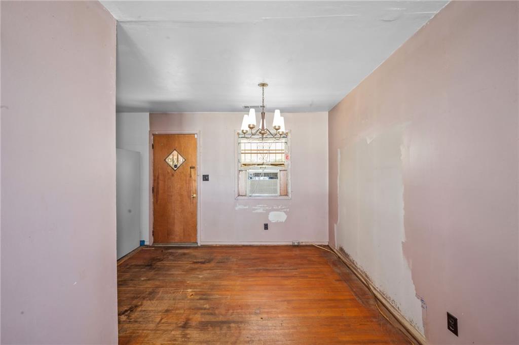 679 Bolton Road Northwest Atlanta, GA 30331 - Photo 7 of 30 wooden floor in an empty room with a window