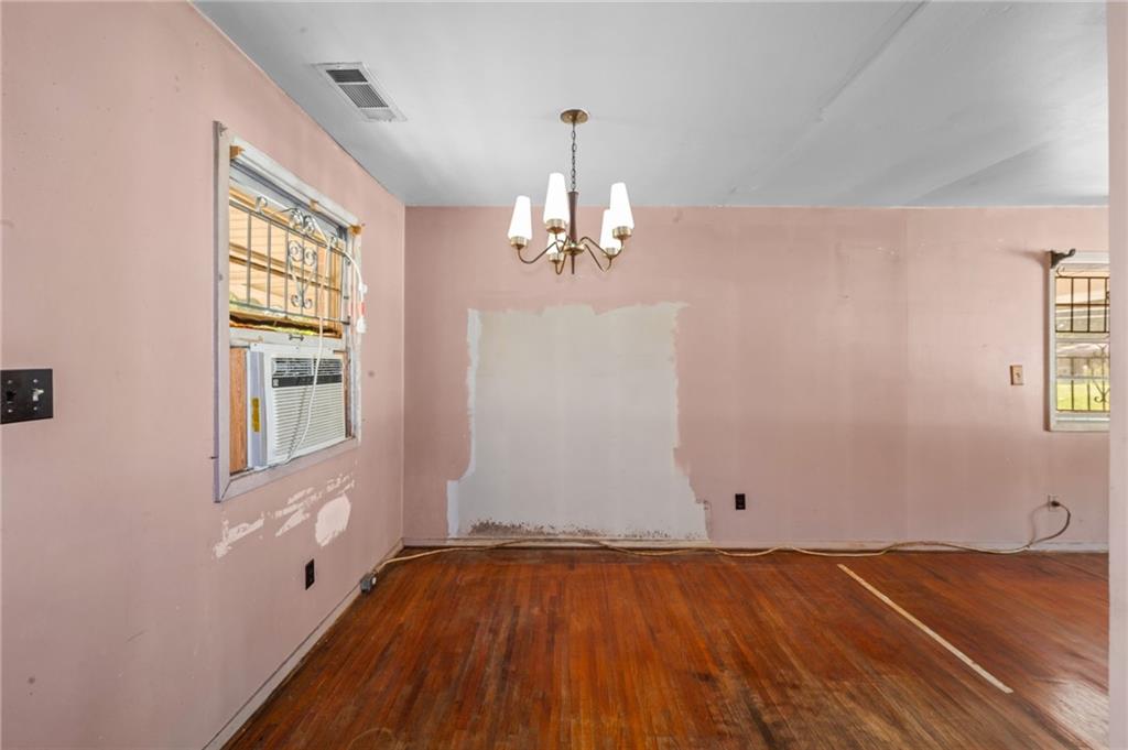 679 Bolton Road Northwest Atlanta, GA 30331 - Photo 9 of 30 wooden floor in an empty room with a window