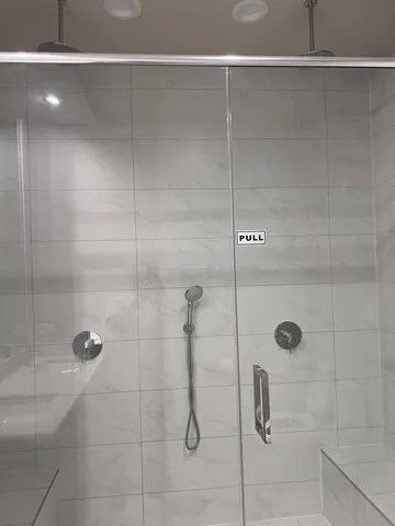 a view of bathroom with a sink and mirror