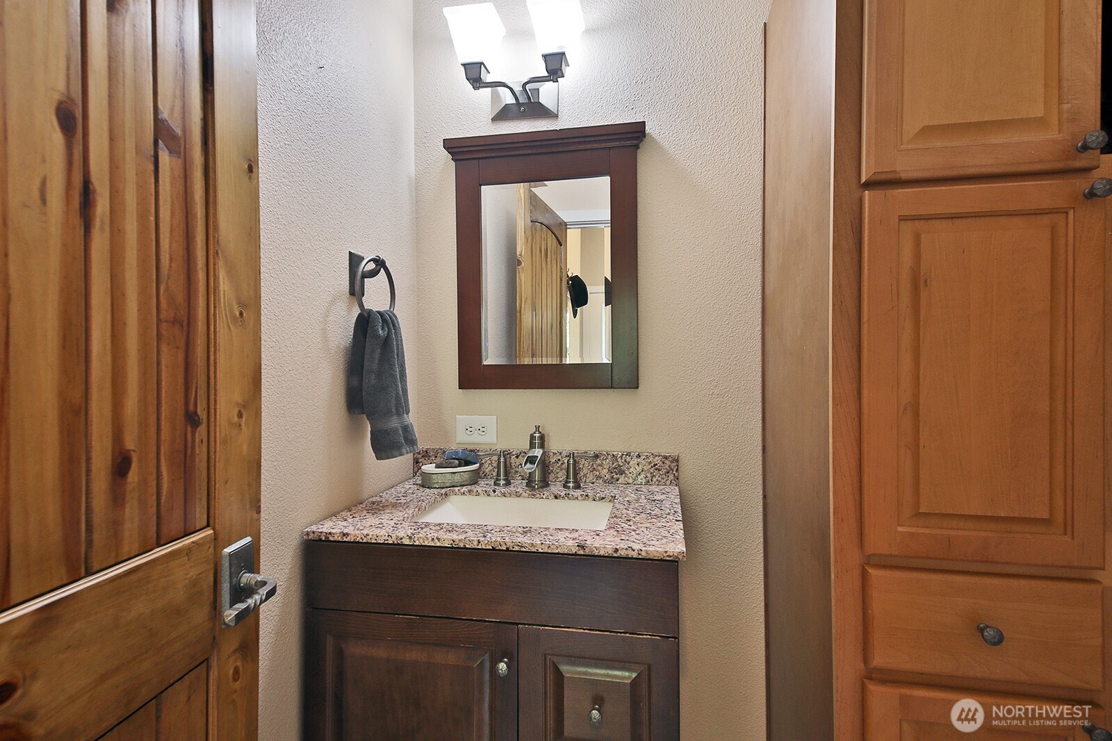 1677 Lancaster Road Freeland, WA 98249 - Photo 14 of 40 a bathroom with a granite countertop sink and a mirror