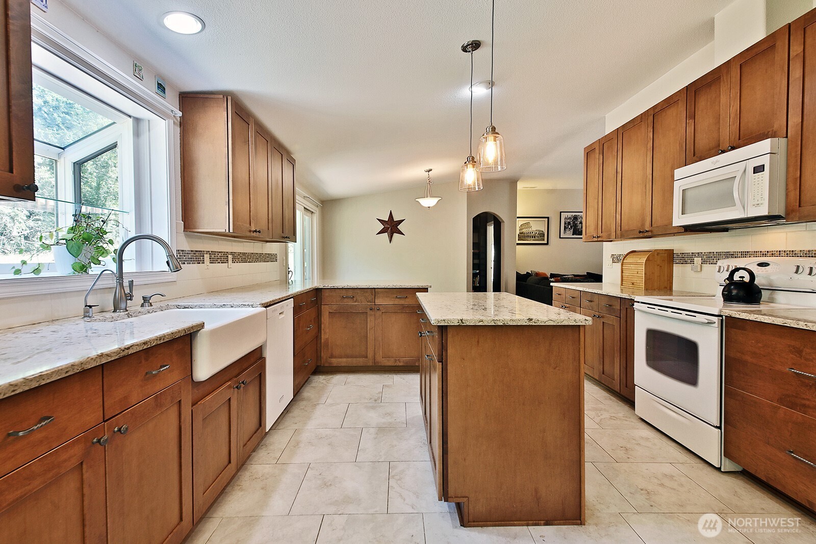 1677 Lancaster Road Freeland, WA 98249 - Photo 16 of 40 a kitchen with a sink stove and cabinets