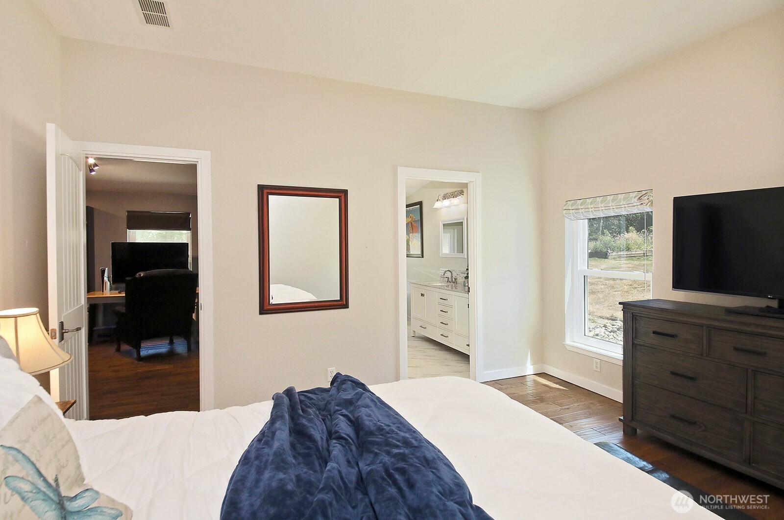 1677 Lancaster Road Freeland, WA 98249 - Photo 18 of 40 a bedroom with a bed and a flat screen tv