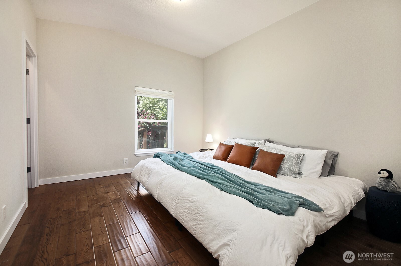 1677 Lancaster Road Freeland, WA 98249 - Photo 23 of 40 a bedroom with a bed and wooden floor