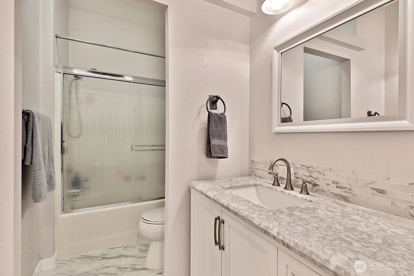 1677 Lancaster Road Freeland, WA 98249 - Photo 26 of 40 a bathroom with a granite countertop sink toilet and shower