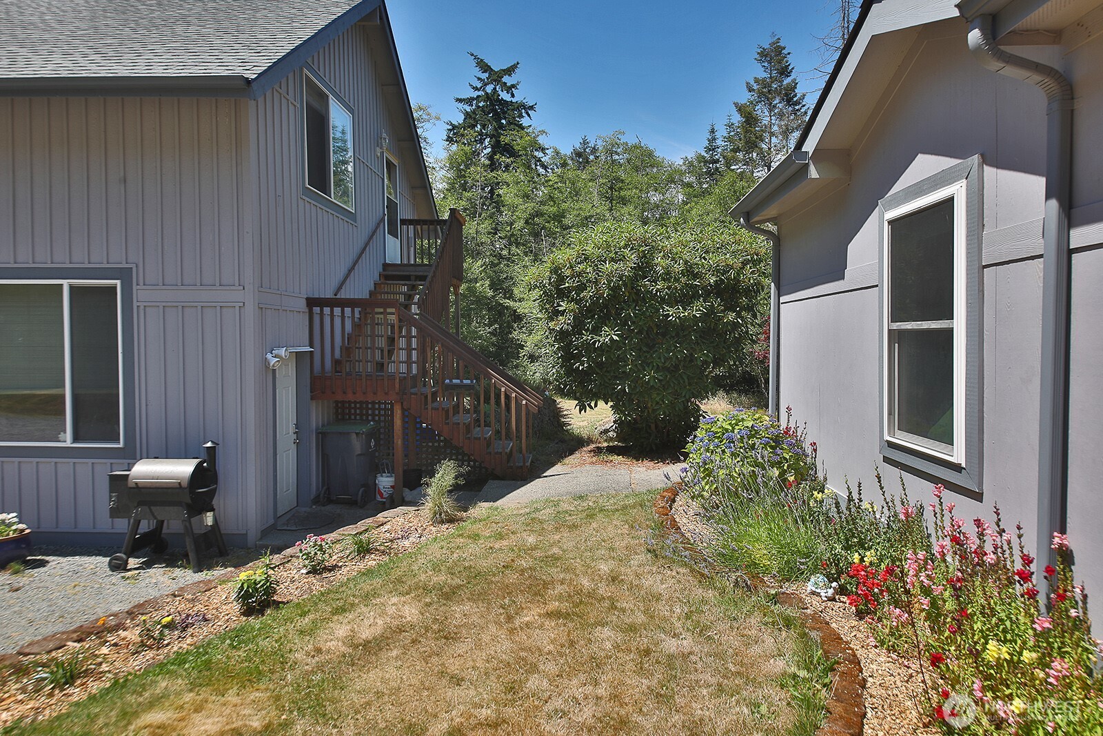 1677 Lancaster Road Freeland, WA 98249 - Photo 29 of 40 a view of a house with a yard and sitting area
