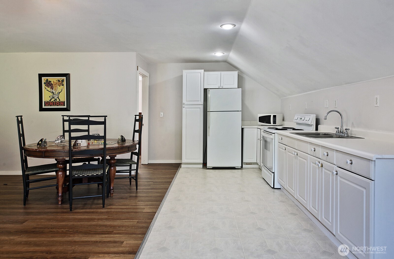 1677 Lancaster Road Freeland, WA 98249 - Photo 30 of 40 a kitchen with white cabinets and wooden floor