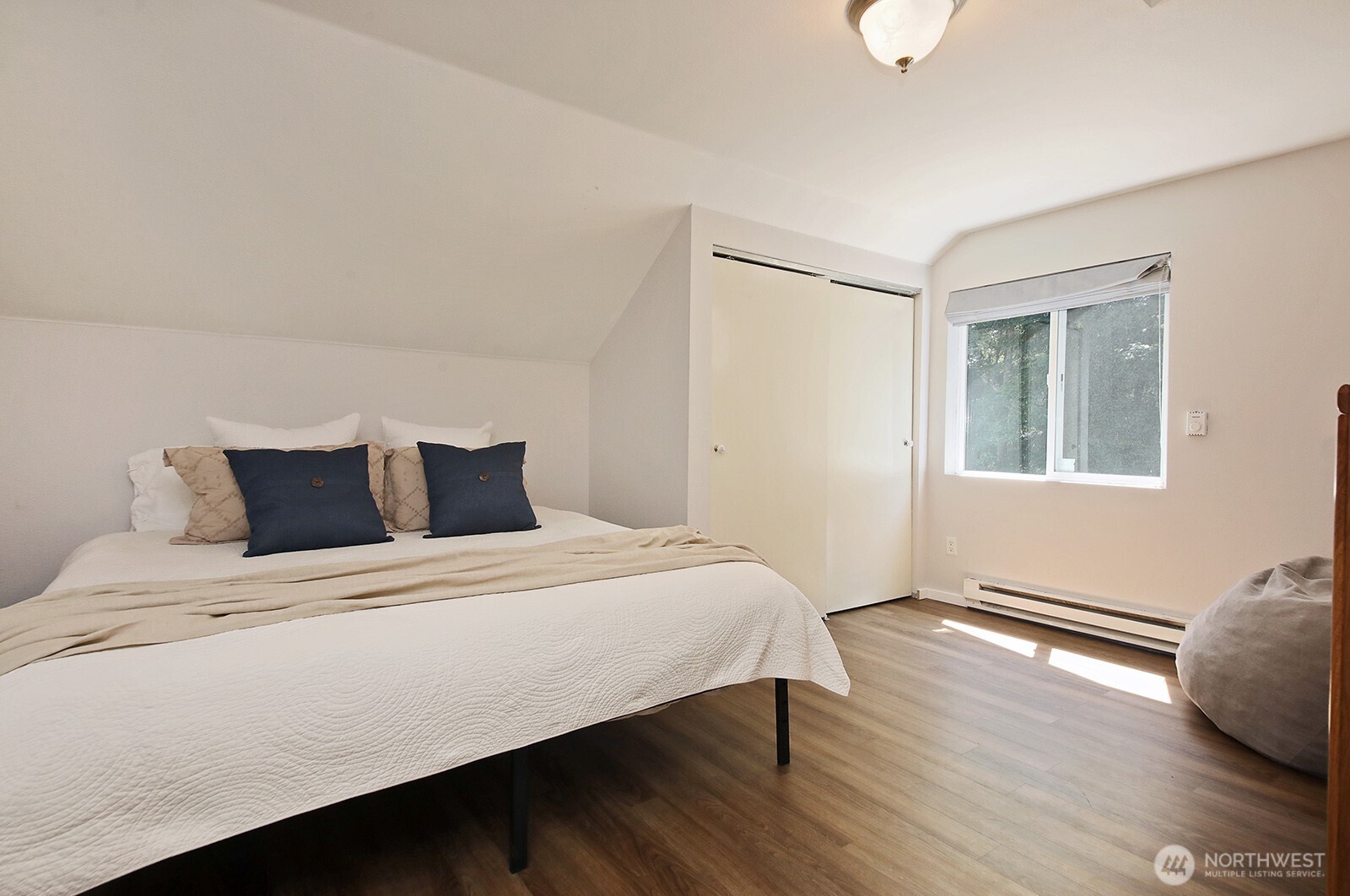 1677 Lancaster Road Freeland, WA 98249 - Photo 33 of 40 a bedroom with a bed and wooden floor