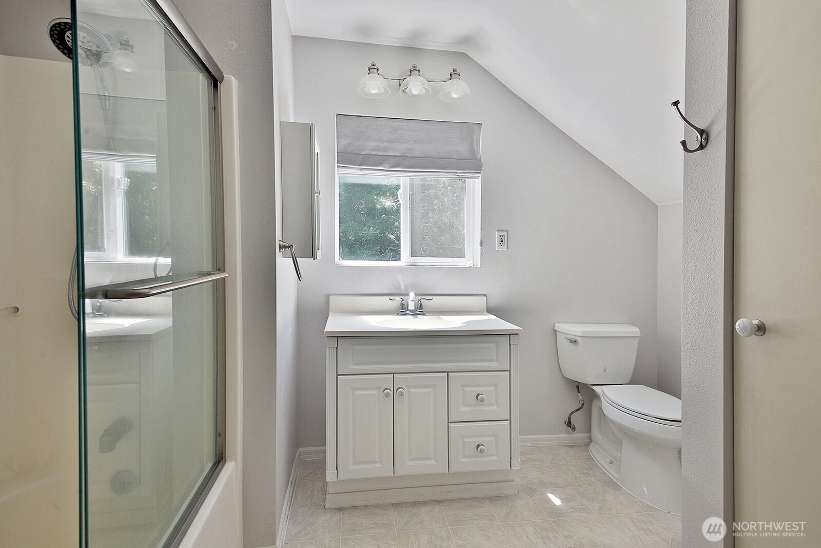 1677 Lancaster Road Freeland, WA 98249 - Photo 34 of 40 a bathroom with a granite countertop toilet a sink and a mirror
