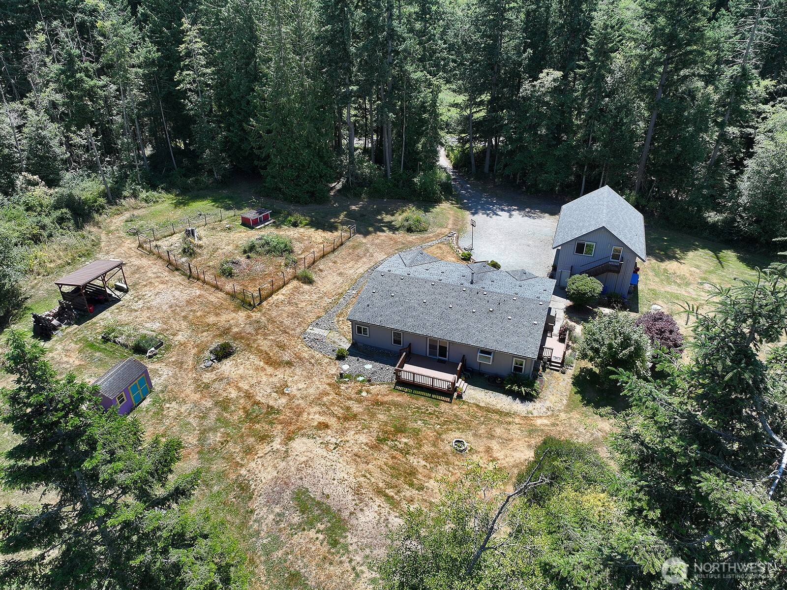 1677 Lancaster Road Freeland, WA 98249 - Photo 4 of 40 a backyard of a house with lots of green space