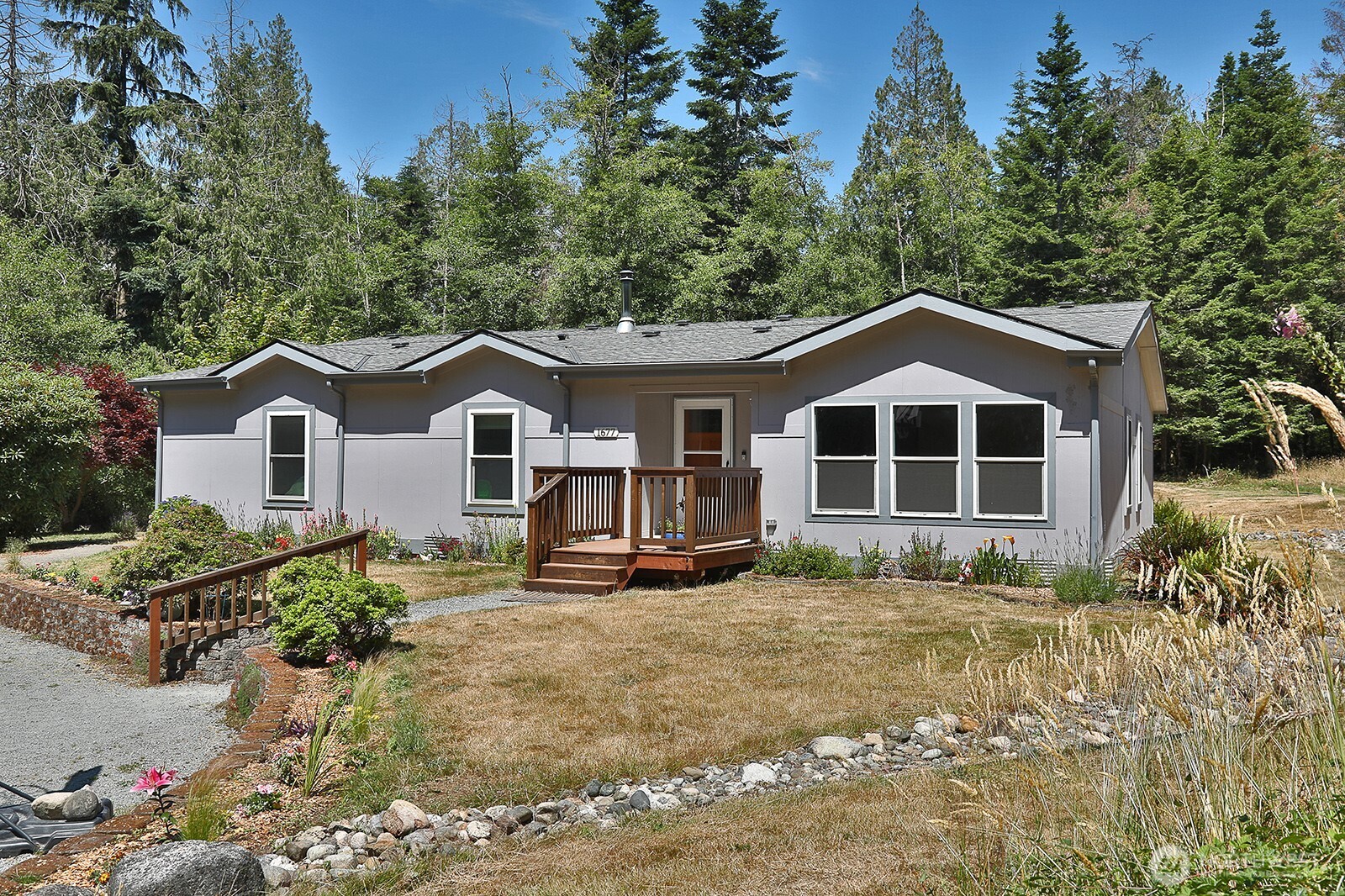 1677 Lancaster Road Freeland, WA 98249 - Photo 6 of 40 a front view of a house with a yard