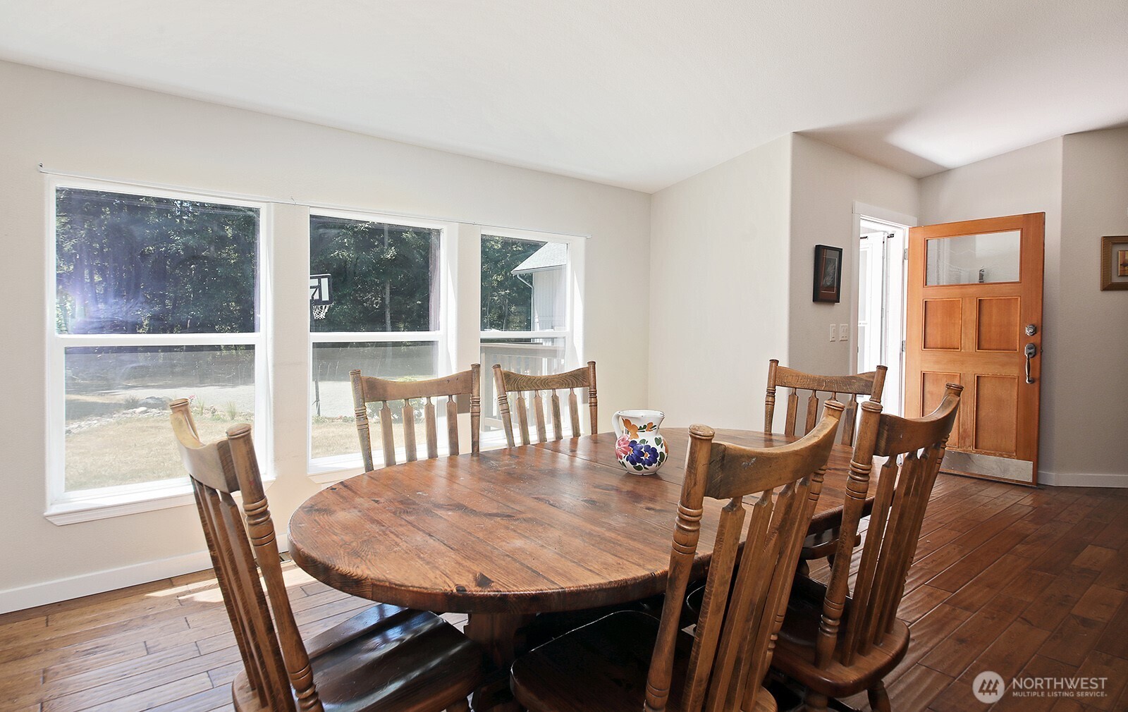 1677 Lancaster Road Freeland, WA 98249 - Photo 10 of 40 a dining room with furniture and wooden floor