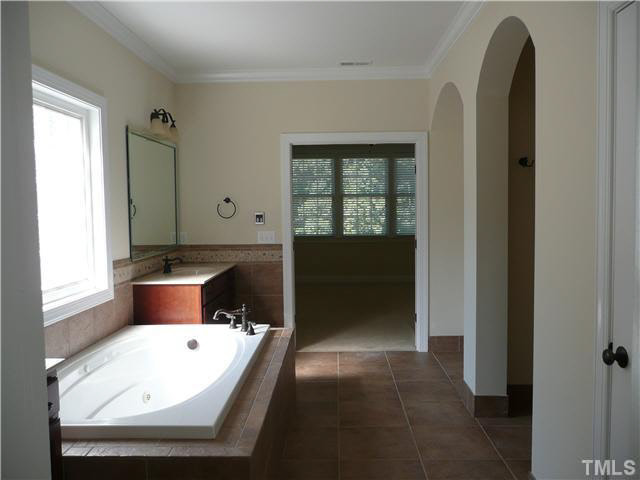 7333 Newport Avenue Raleigh, NC 27613 - Photo 12 of 20 a bathroom with a tub sink and mirror