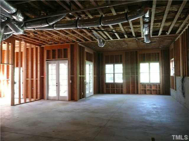 7333 Newport Avenue Raleigh, NC 27613 - Photo 18 of 20 a view of an empty room with wooden floor and windows