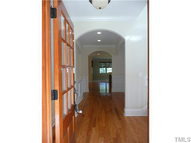 7333 Newport Avenue Raleigh, NC 27613 - Photo 3 of 20 a view of a hallway with wooden floor