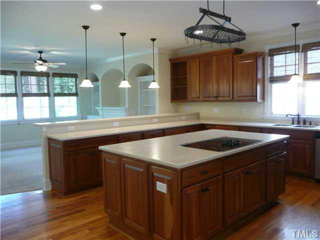 7333 Newport Avenue Raleigh, NC 27613 - Photo 6 of 20 a kitchen with a sink a counter space appliances and cabinets
