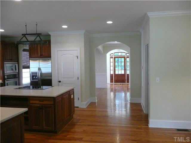 7333 Newport Avenue Raleigh, NC 27613 - Photo 7 of 20 a kitchen with stainless steel appliances granite countertop a sink a stove a refrigerator and a window