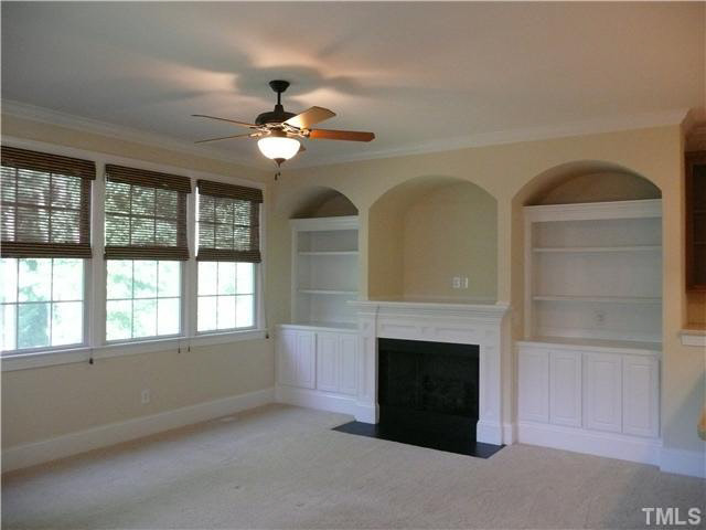 7333 Newport Avenue Raleigh, NC 27613 - Photo 10 of 20 a view of empty room with fireplace and fan