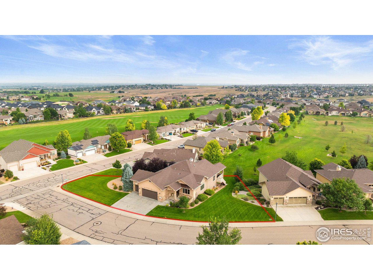 an aerial view of a house with a garden and lake view