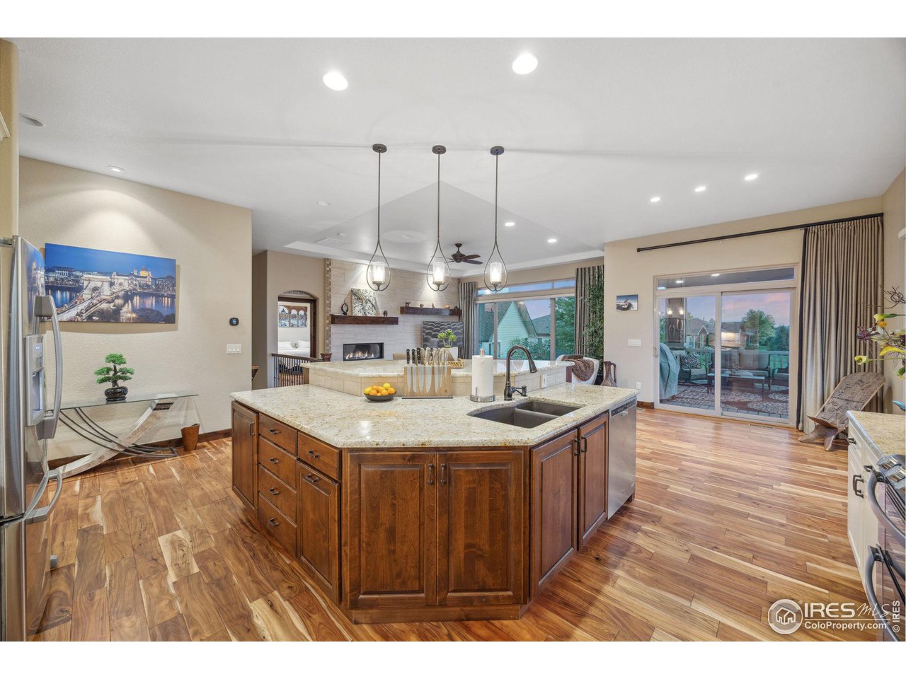 6178 Bay Meadows Drive Windsor, CO 80550 - Photo 12 of 40 a kitchen with a sink and wooden floor