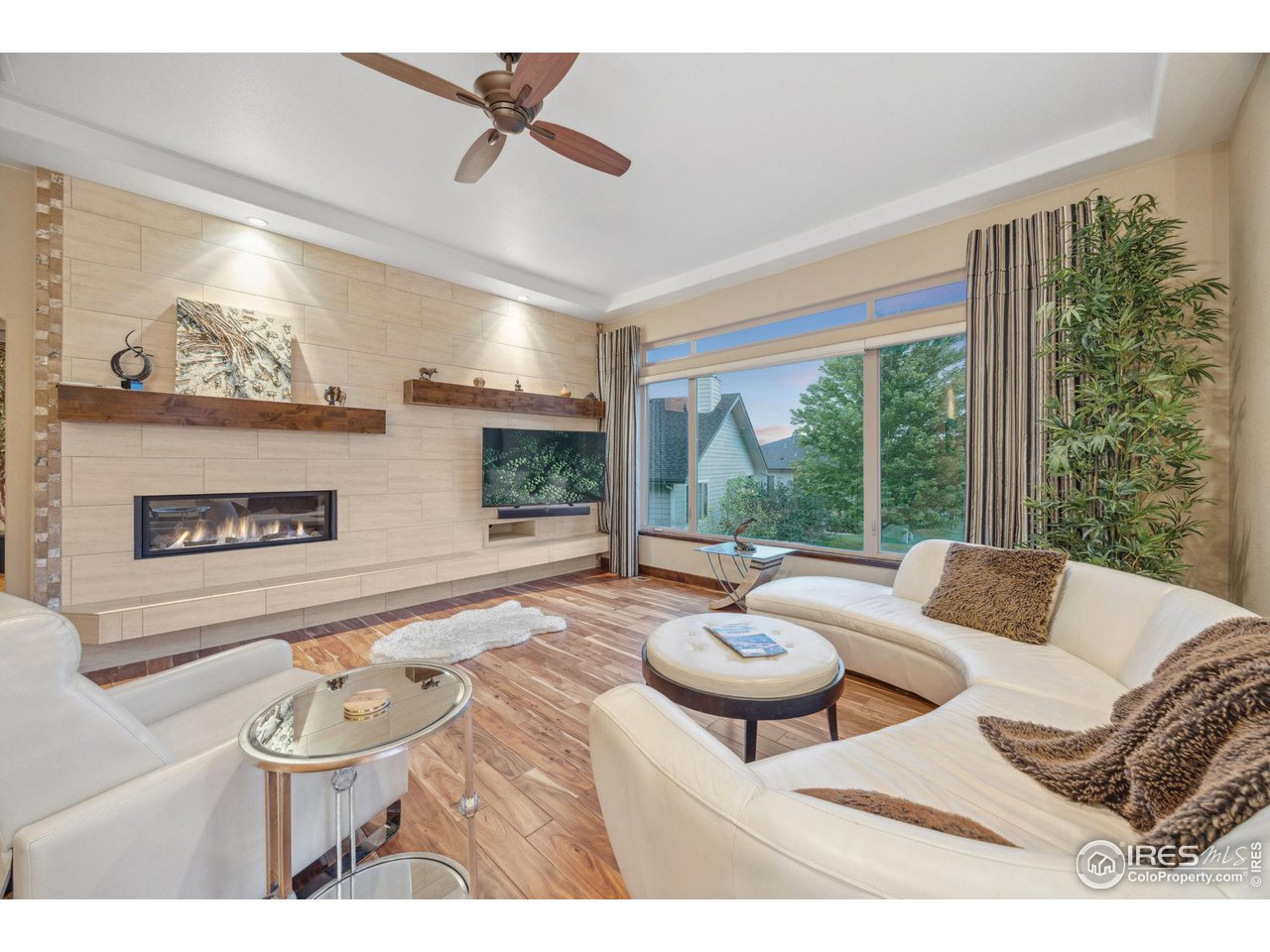 6178 Bay Meadows Drive Windsor, CO 80550 - Photo 16 of 40 a living room with furniture and a large window