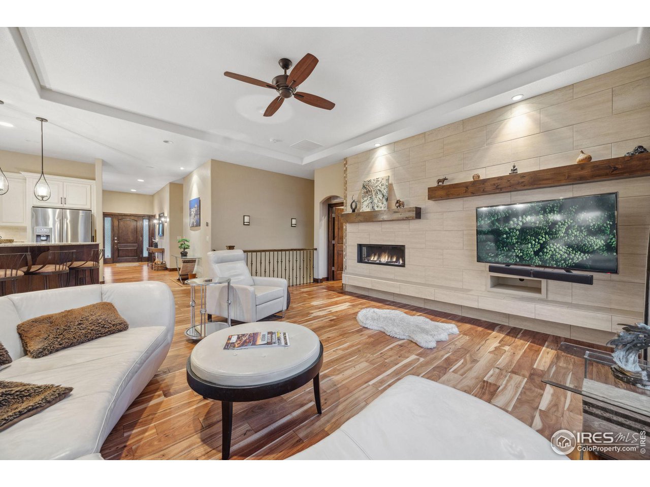 6178 Bay Meadows Drive Windsor, CO 80550 - Photo 17 of 40 a living room with furniture and a flat screen tv