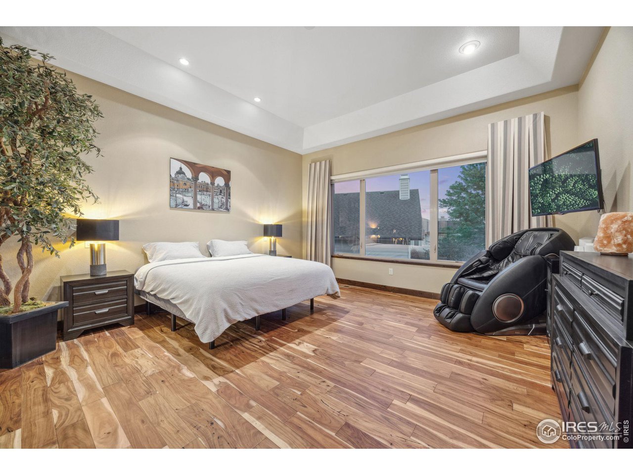 6178 Bay Meadows Drive Windsor, CO 80550 - Photo 20 of 40 a bedroom with a bed and a large window