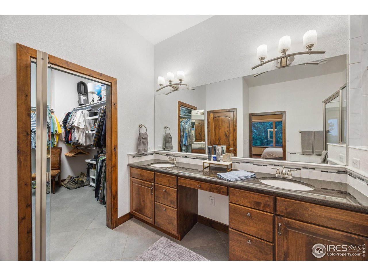6178 Bay Meadows Drive Windsor, CO 80550 - Photo 22 of 40 a bathroom with a sink and a mirror