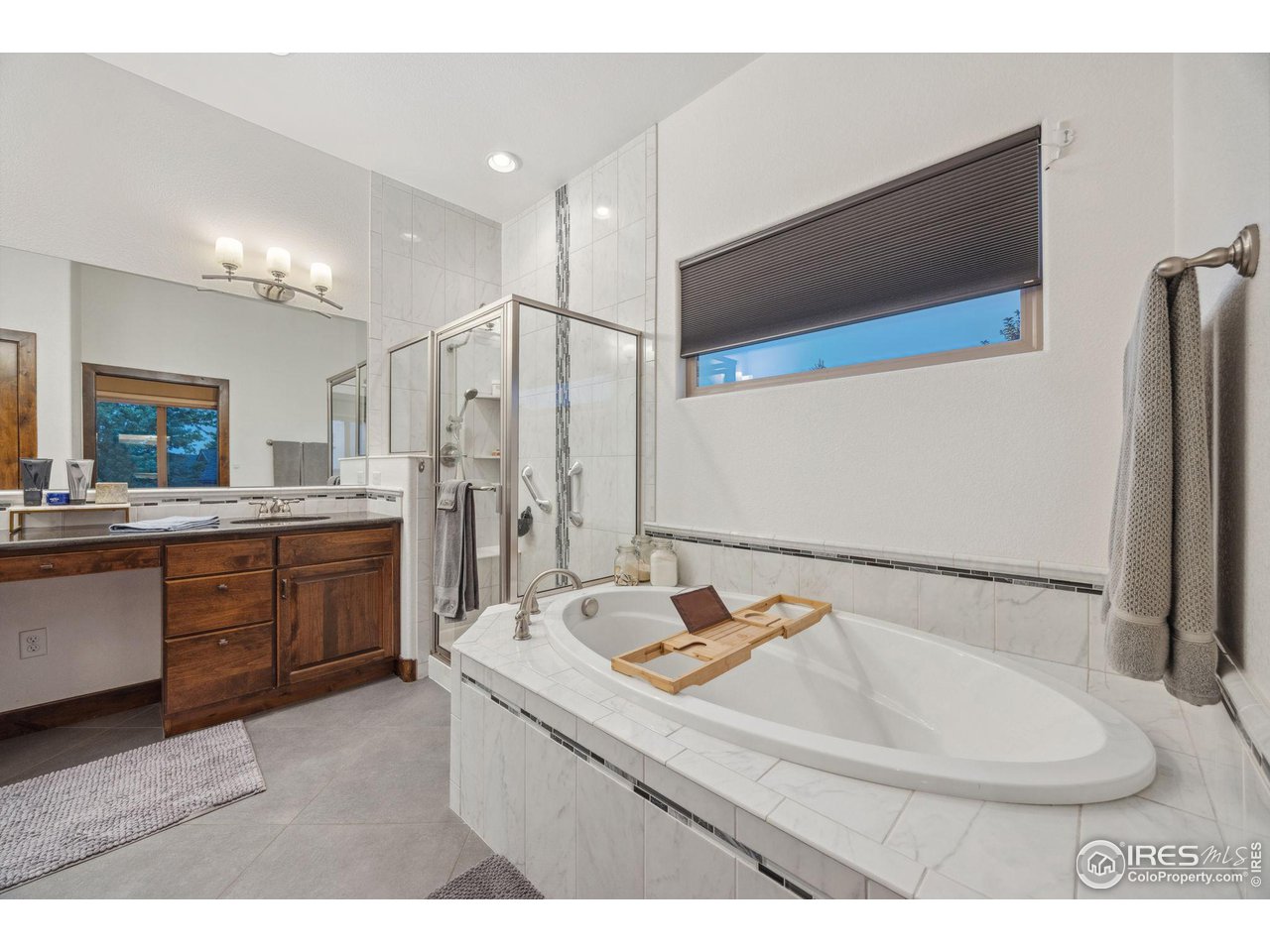 6178 Bay Meadows Drive Windsor, CO 80550 - Photo 23 of 40 a bathroom with a sink and a mirror